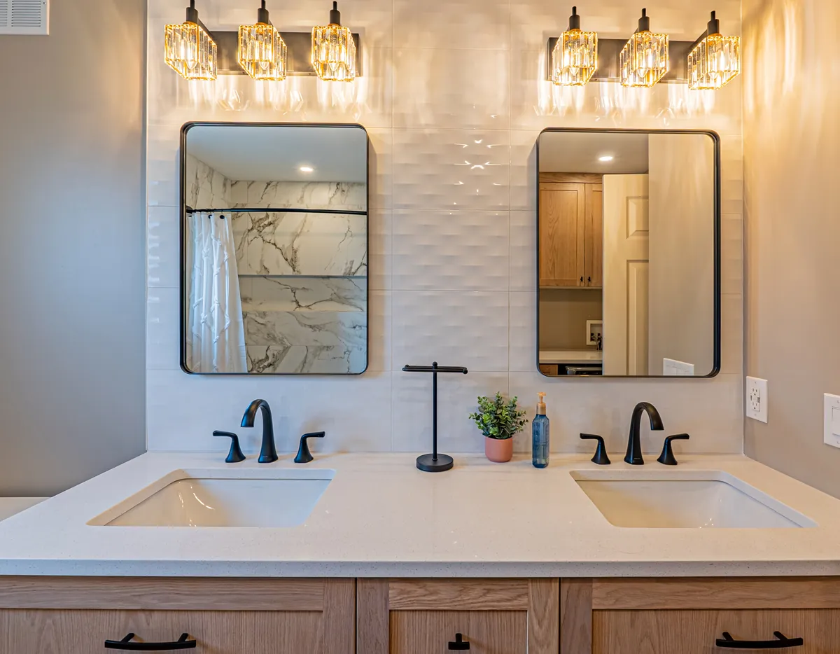 Double vanity under crystal sconces