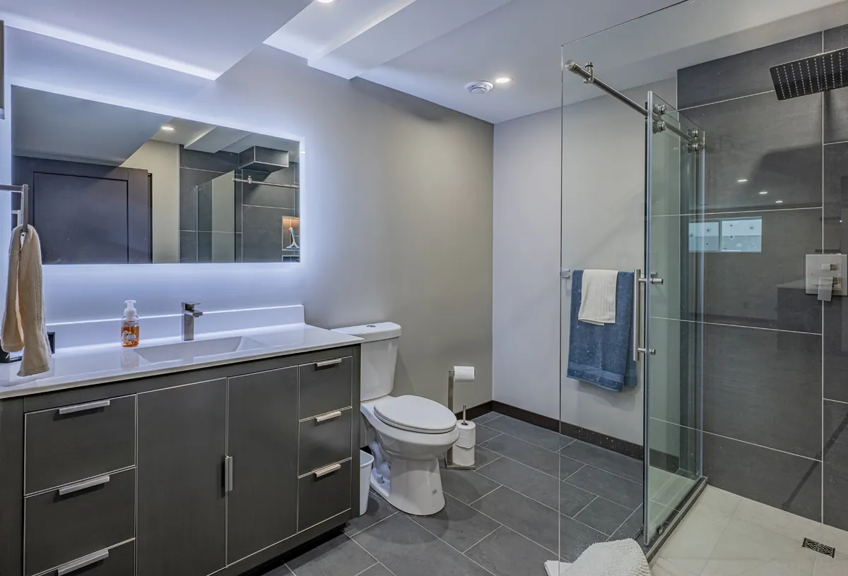 Ensuite with backlit LED mirror and glass shower