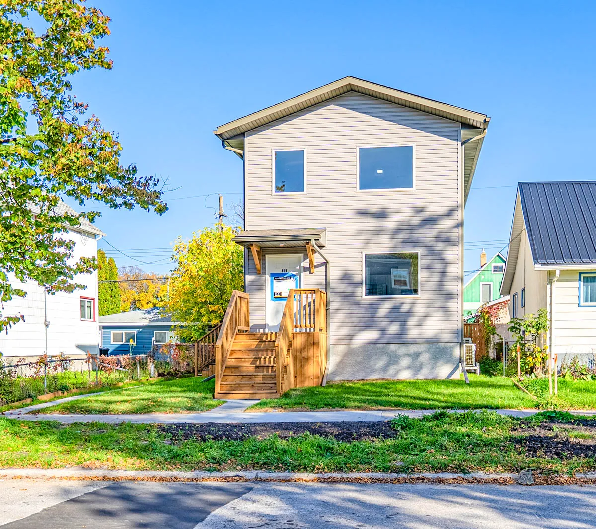New-build home exterior with front deck and steps