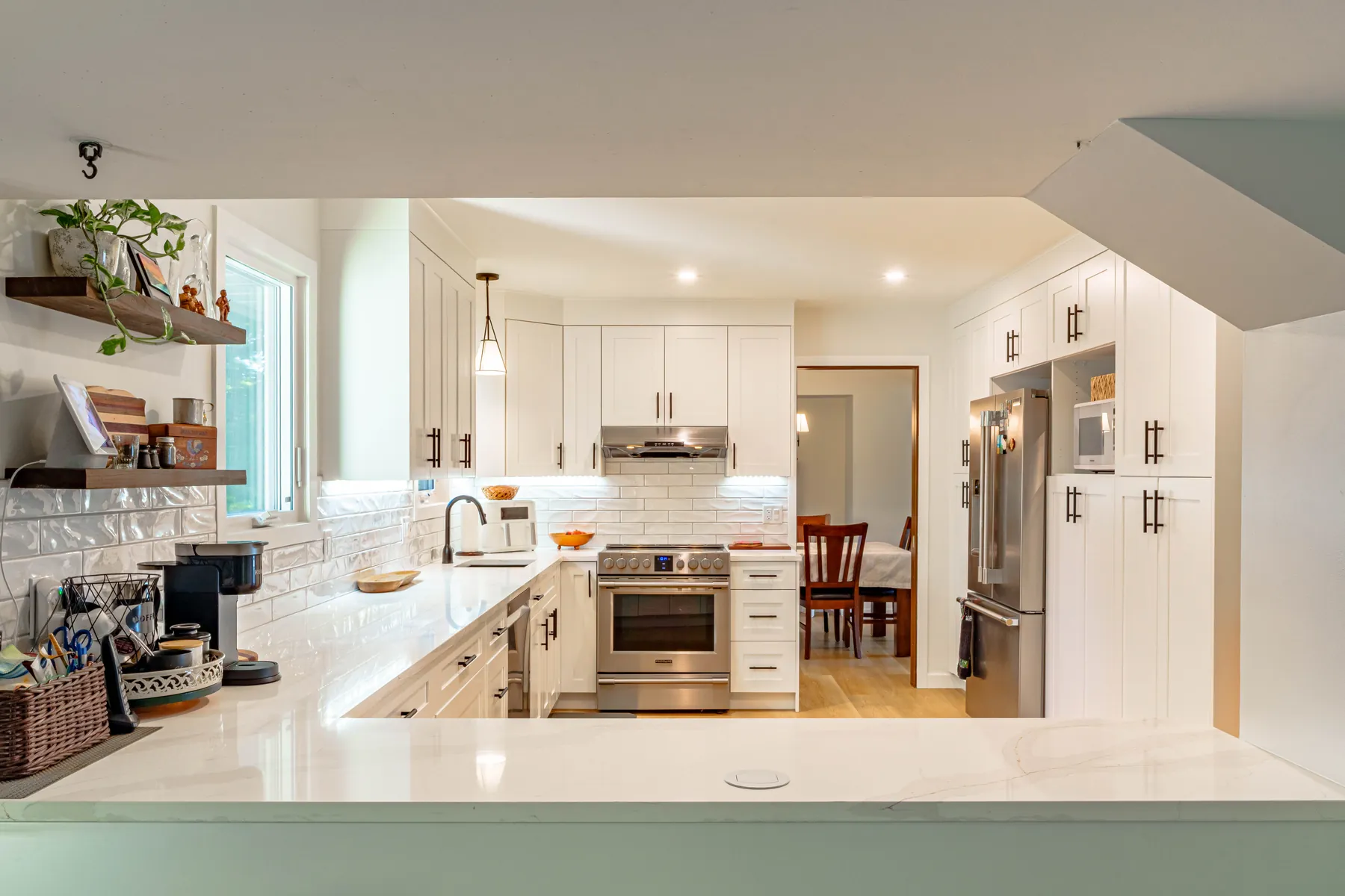 White shaker kitchen open to dining