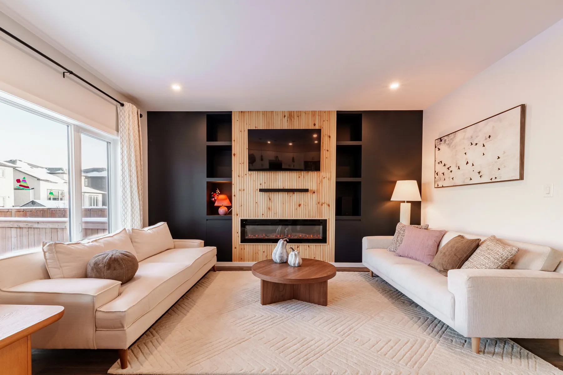 Living room with wood feature wall and linear fireplace