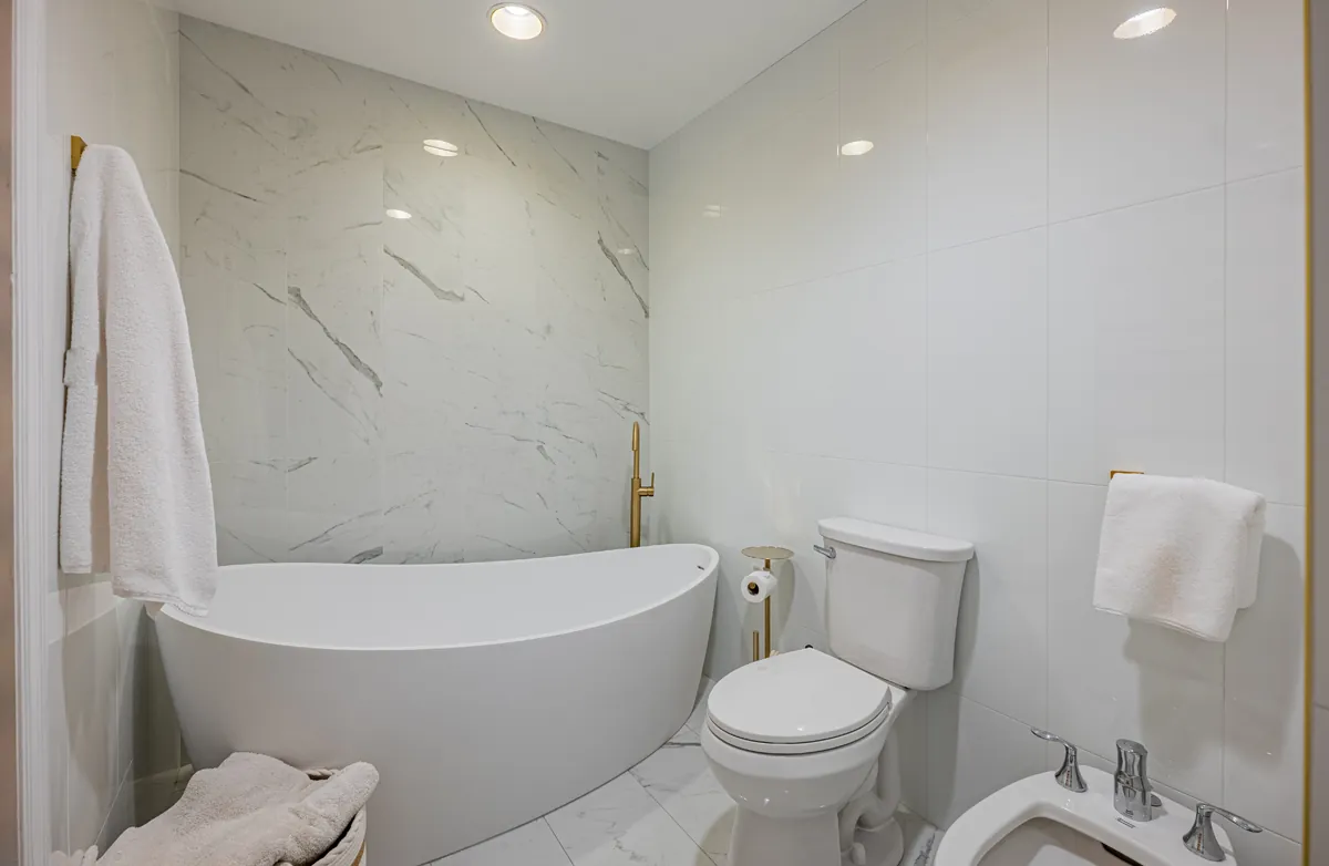 Freestanding soaker tub in marble bath